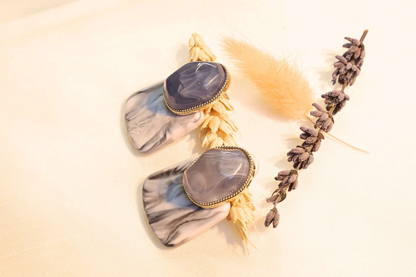 Bold and modern earrings featuring luxurious purple and gray marbled resin.