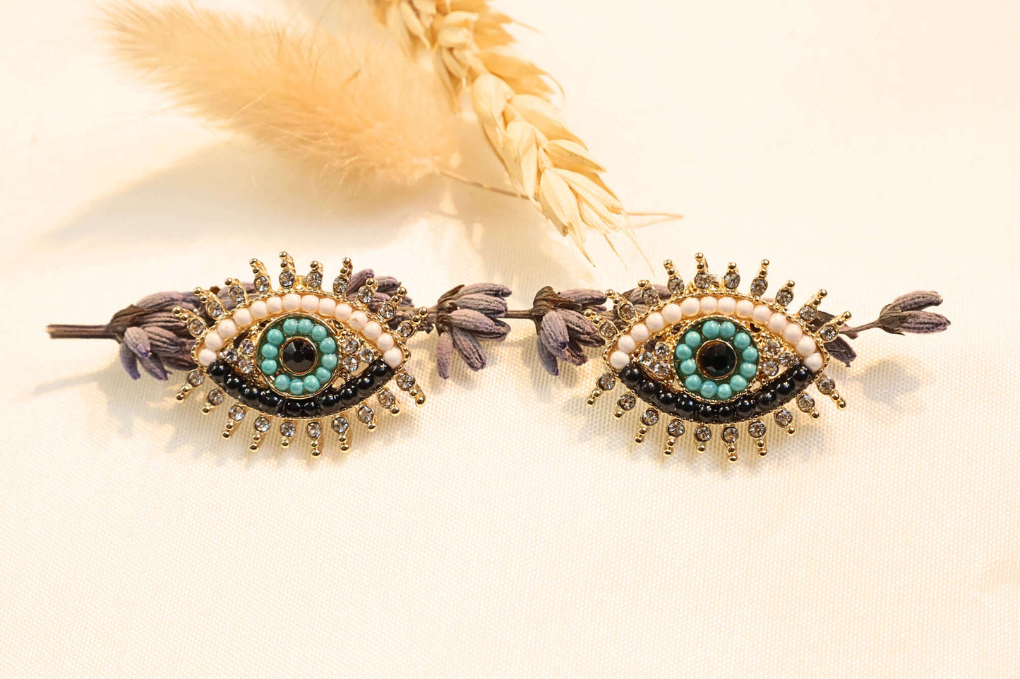 Elegant gold earrings with mystic eye symbolism, blending style and protection in a unique, statement-worthy accessory.