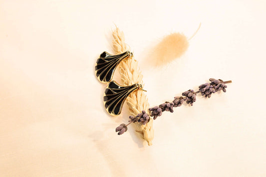 Black seashell earrings with a polished gold finish-bold, sophisticated, and perfect for any statement look.