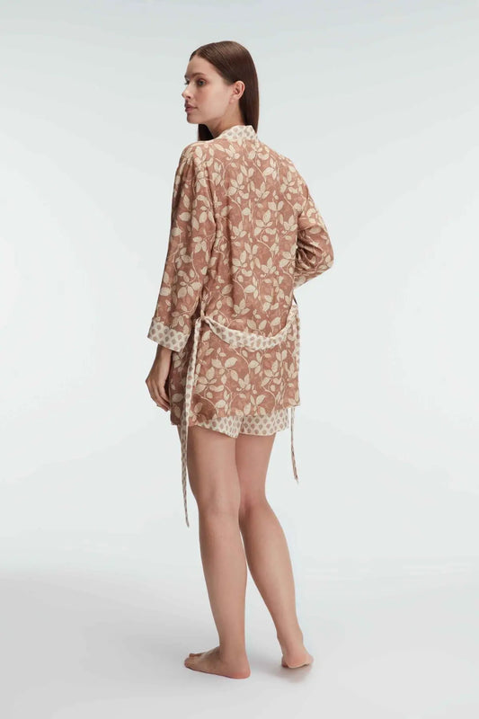 Side profile showcasing the relaxed fit of the woven shorts and the lightweight kimono with a boho-inspired print.