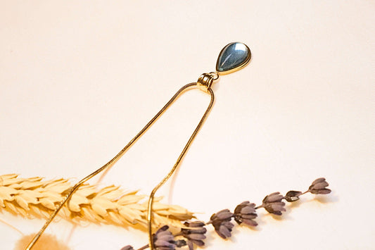 Teardrop turquoise stone gold-plated necklace, elegant and sophisticated design.