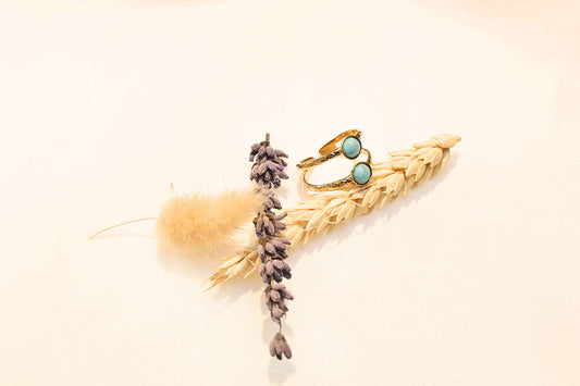 TwinAura ring, featuring a shiny gold-plated finish and elegant twin-stone effect