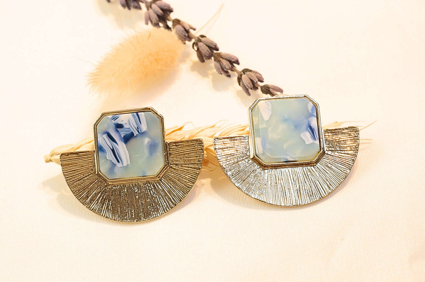 Gold statement earrings featuring cool blue hues, ideal for adding a fresh and stylish touch to your look.