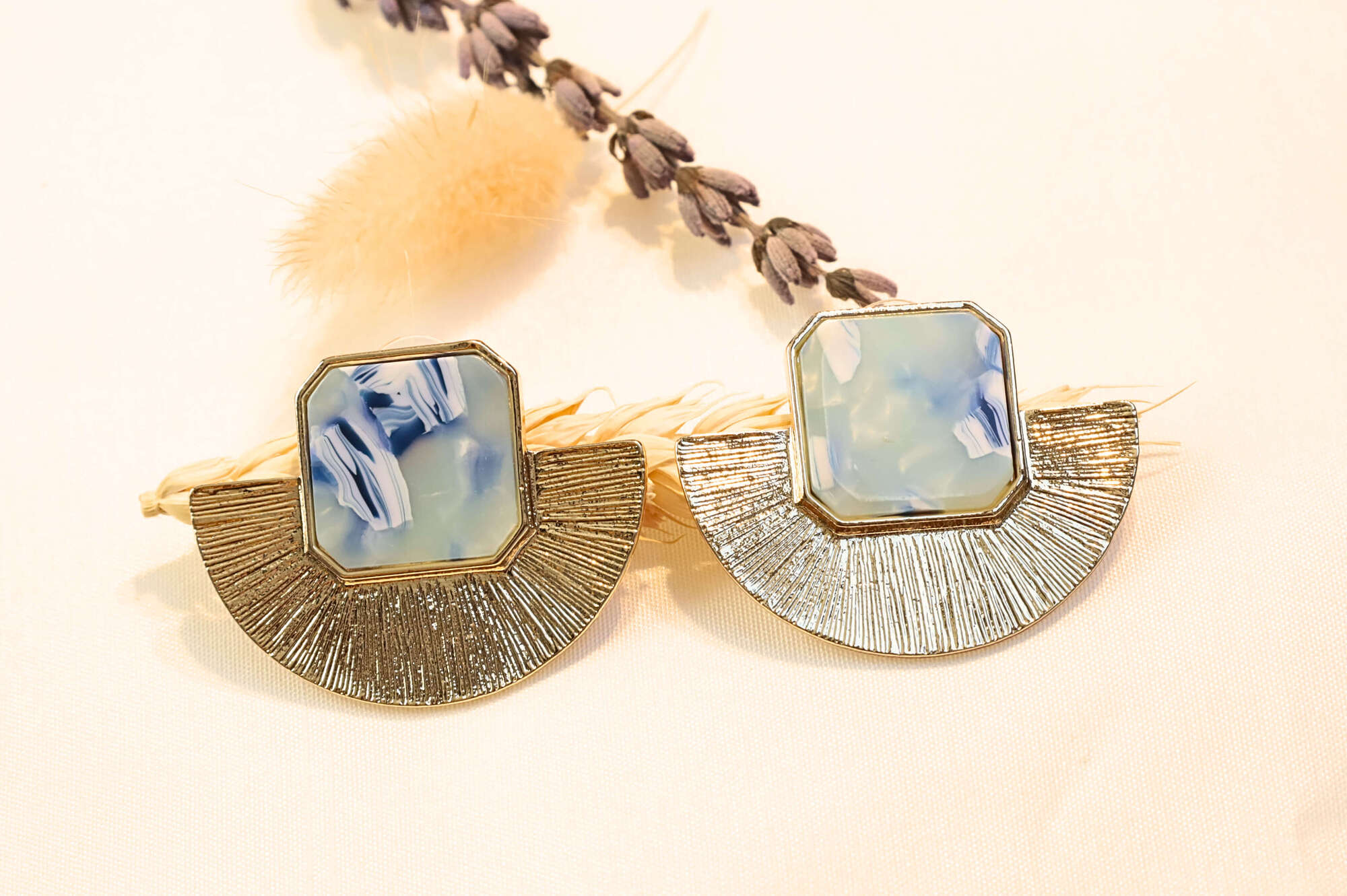 Gold statement earrings featuring cool blue hues, ideal for adding a fresh and stylish touch to your look.