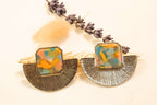 Vibrant gold-plated earrings with multicolored orange details, radiating warmth and artistic charm