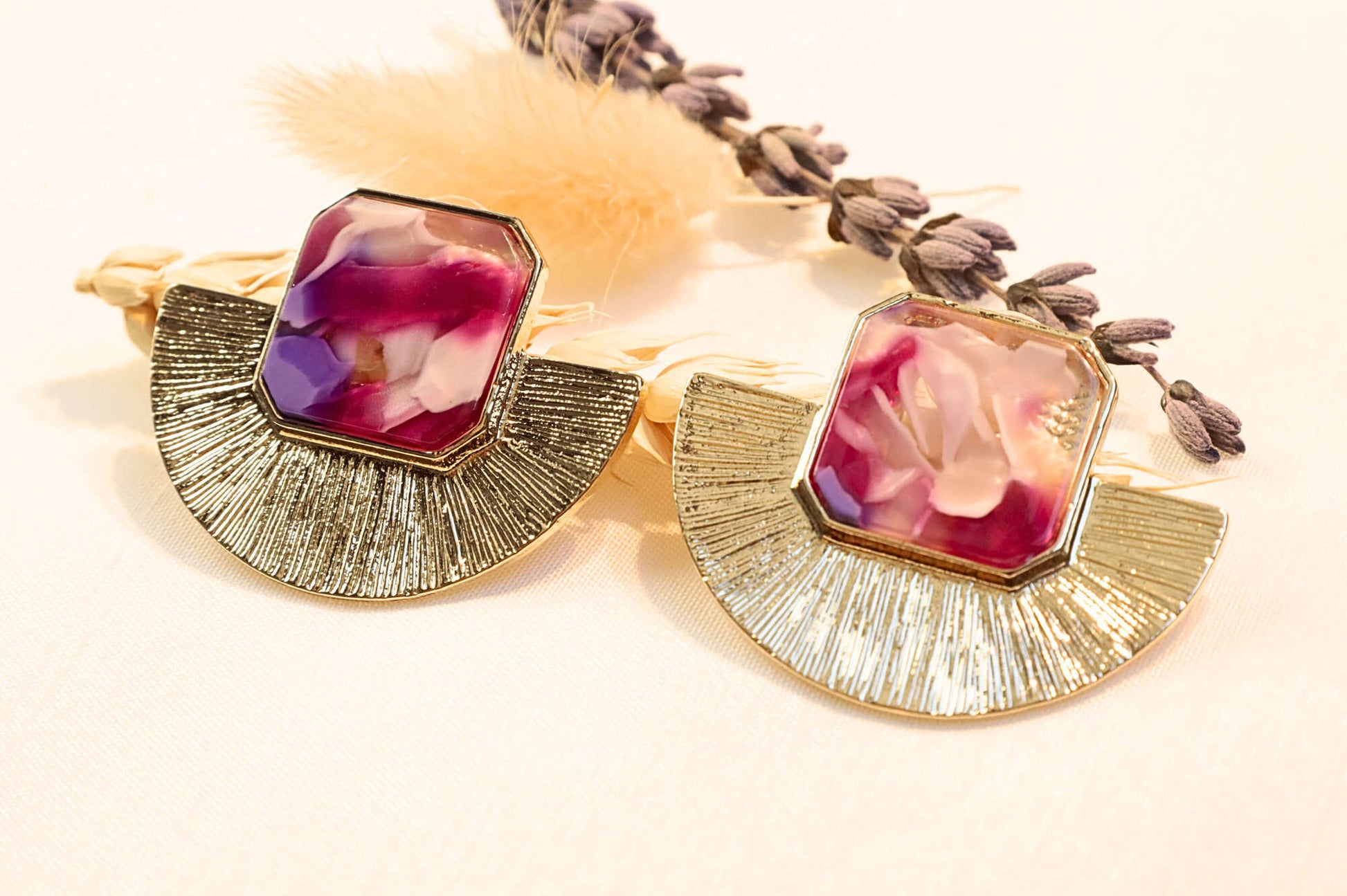 Gold-plated statement earrings with deep red and pink hues, adding a bold and luxurious touch to any outfit.