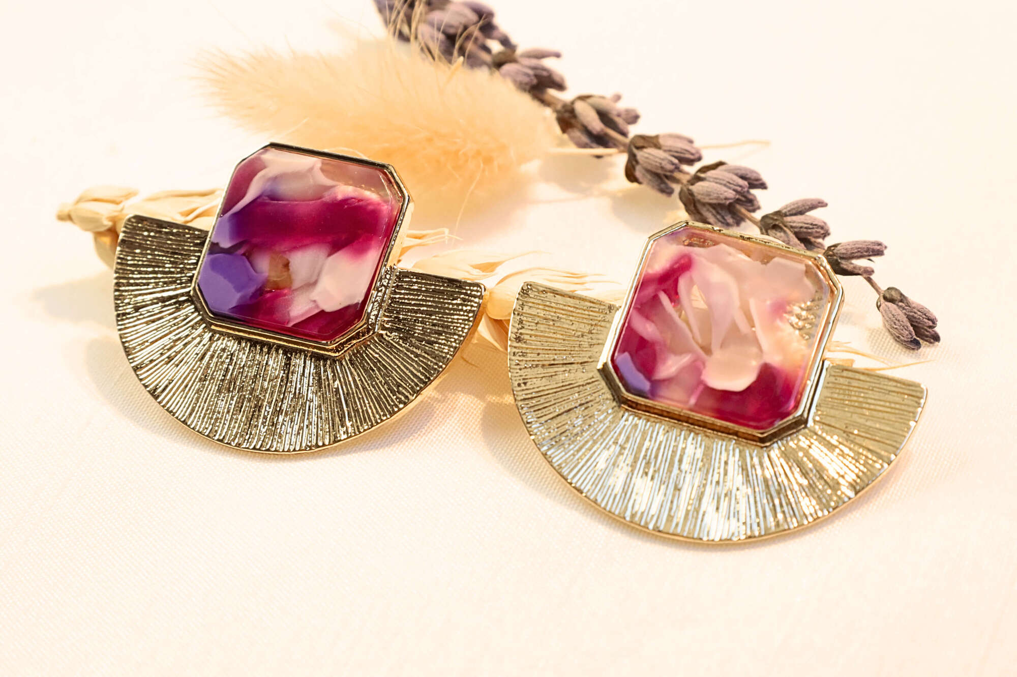 Gold-plated statement earrings with deep red and pink hues, adding a bold and luxurious touch to any outfit.