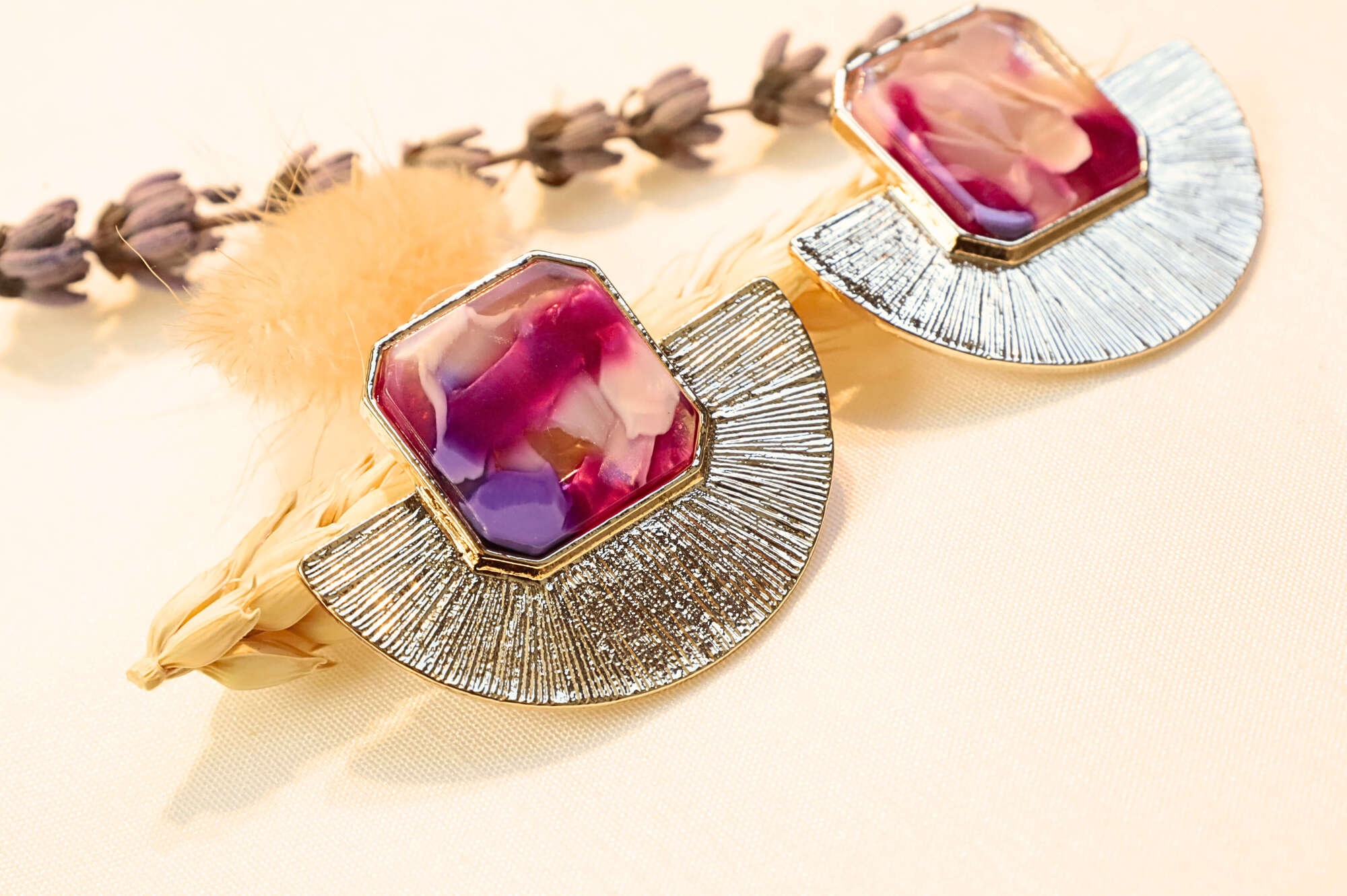 Elegant gold earrings featuring a striking red-pink resin stone, a perfect blend of modern and vintage aesthetics.