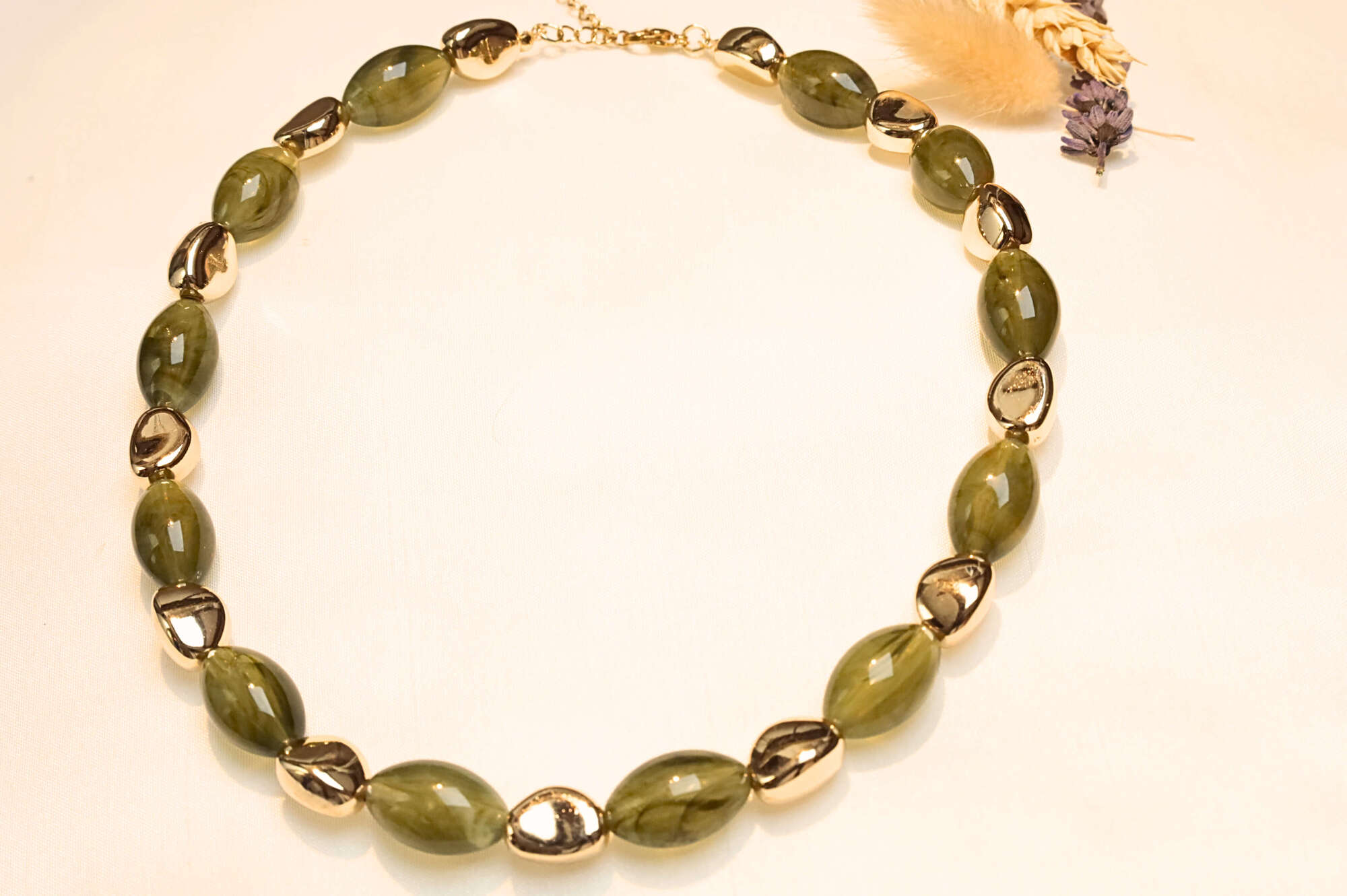 Bohemian gold-plated necklace with green stone effect.