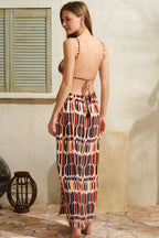 Flowy maxi dress with daring cut-out details and high slit for effortless elegance and boho style.