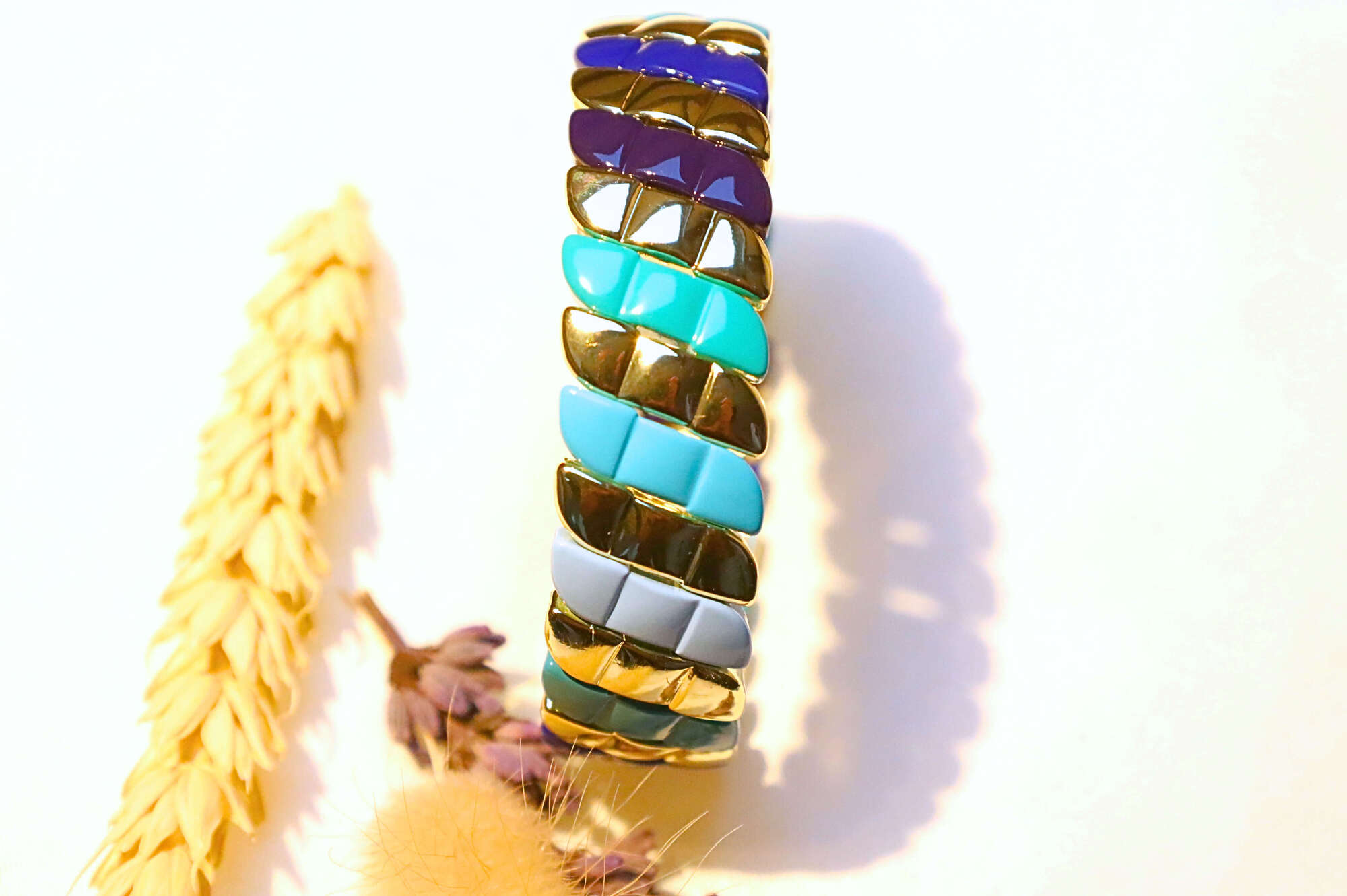 A unique bracelet featuring blue and turquoise enamel links, blending boho charm with modern elegance.