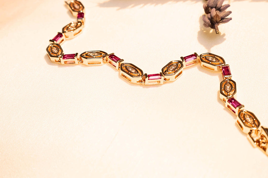 Luxury gold bracelet with red stones, a sophisticated and timeless jewelry piece.