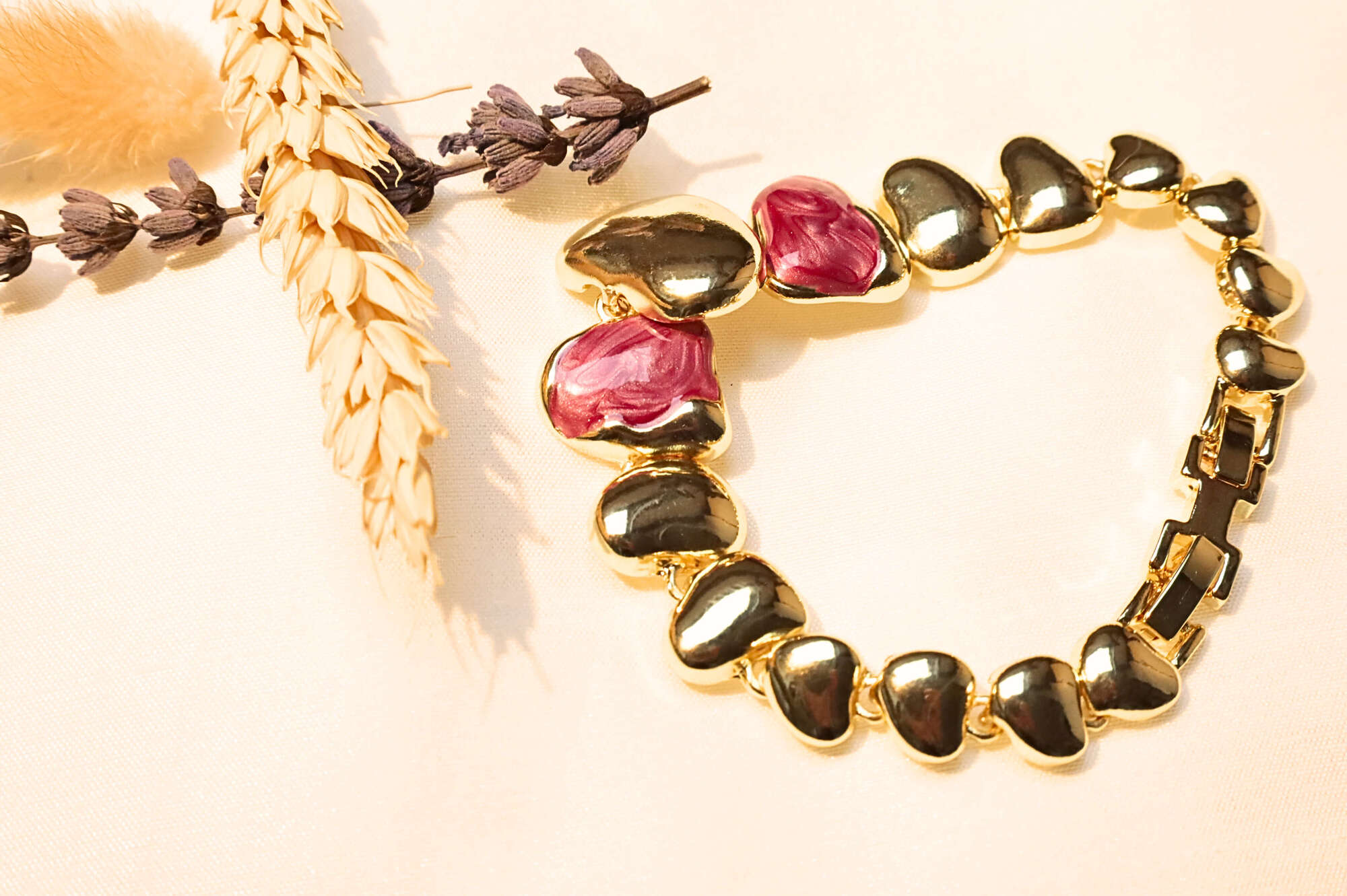 Gold-plated heart bracelet with red gemstones, reflecting love and elegance. A perfect romantic gift for any occasion.