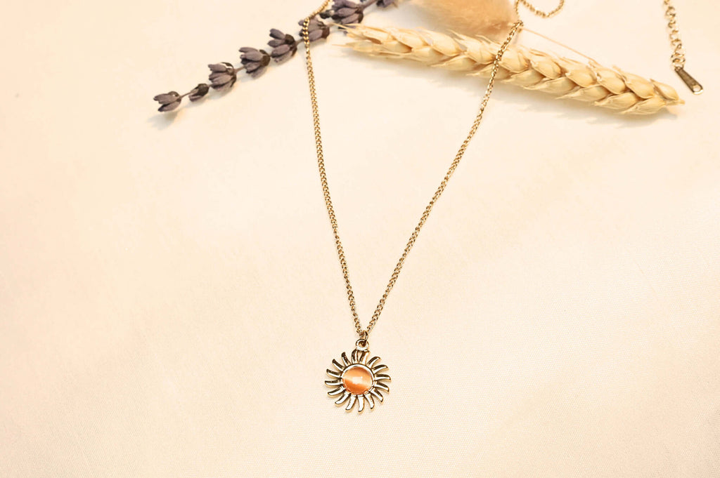 Shiny sun necklace with an adjustable chain for a comfortable fit.