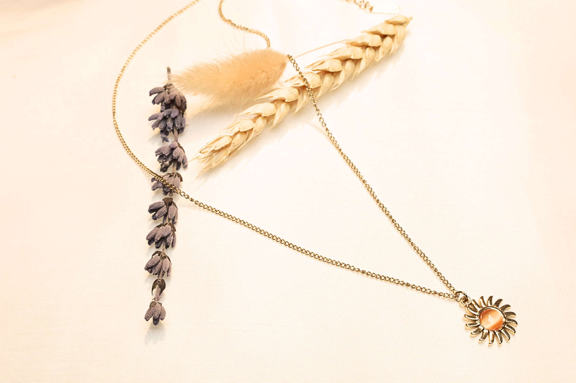 Elegant sun pendant necklace with gold-tone chain, perfect for adding a radiant touch to any outfit.