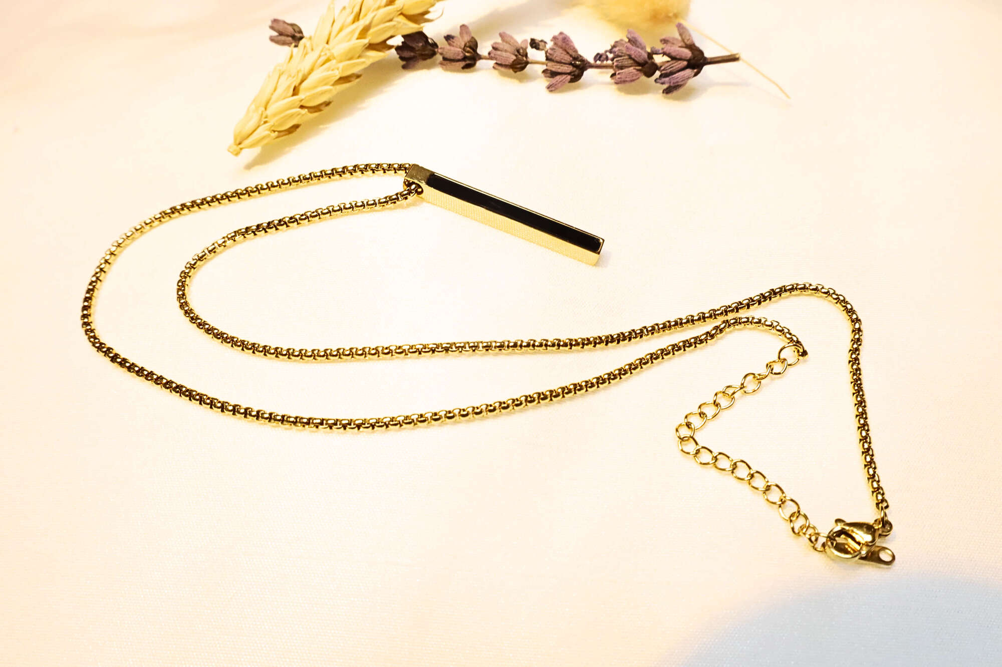 Elegant gold-toned bar pendant necklace with a sleek, modern chain. Perfect for layering or solo styling.