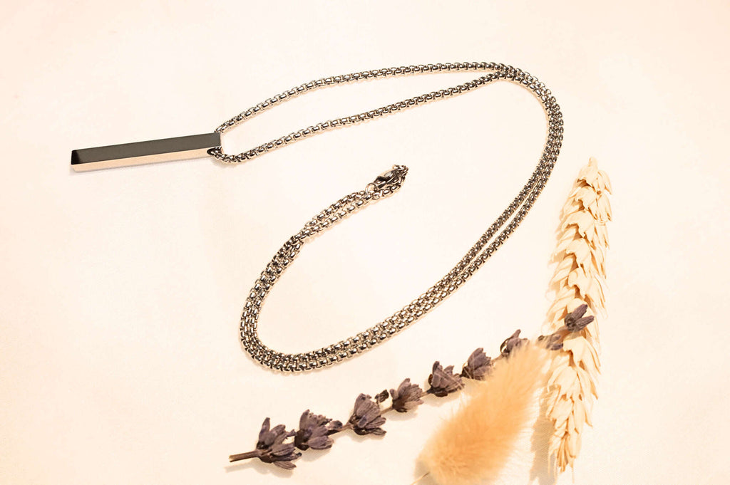 Sleek silver bar pendant necklace with a modern, unisex design. Perfect for casual and formal looks.