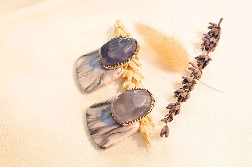 Bold and modern earrings featuring luxurious purple and gray marbled resin.