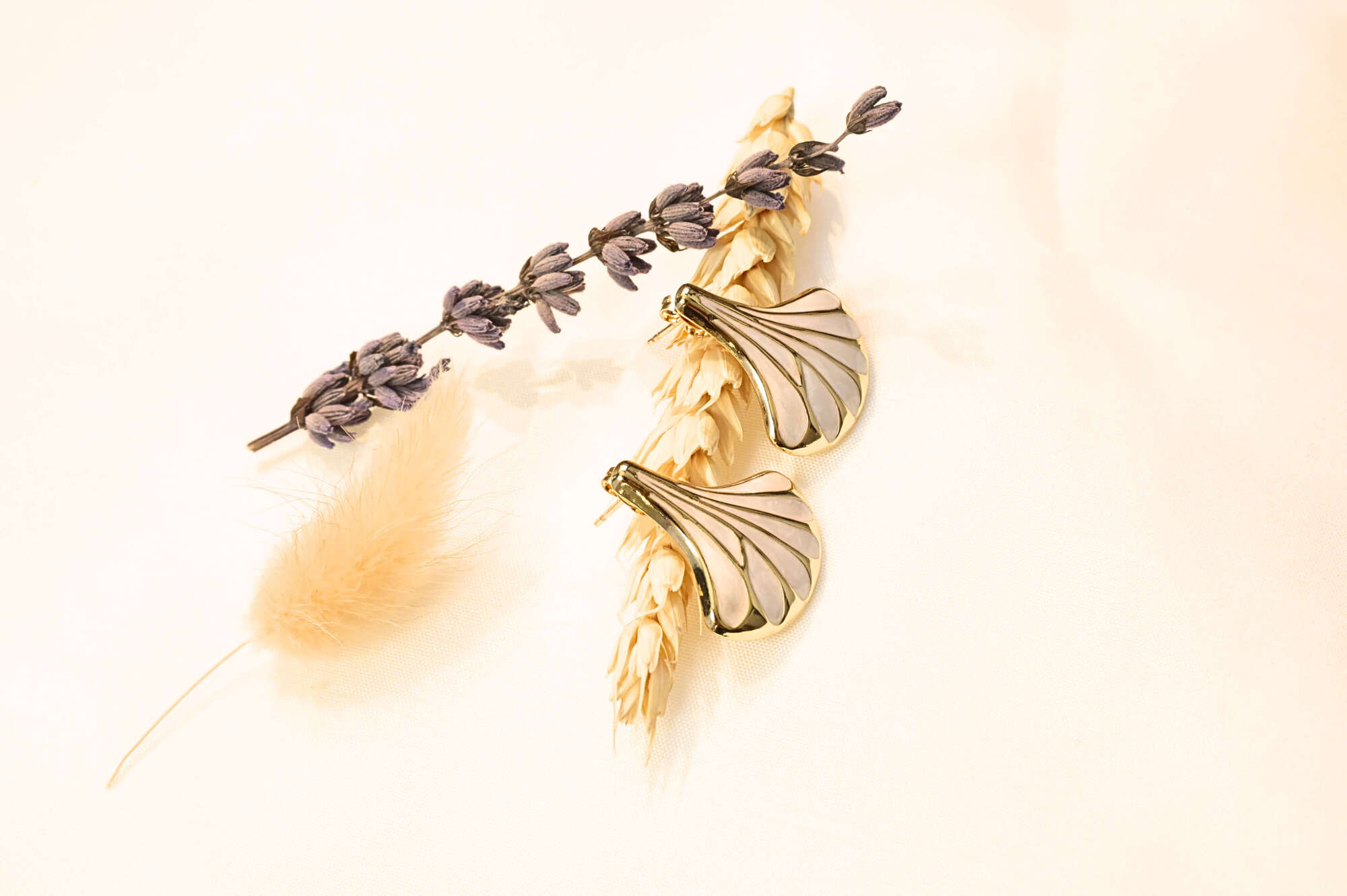 Gold-accented seashell earrings with an elegant design, perfect for any outfit. Available in white, black, and turquoise.