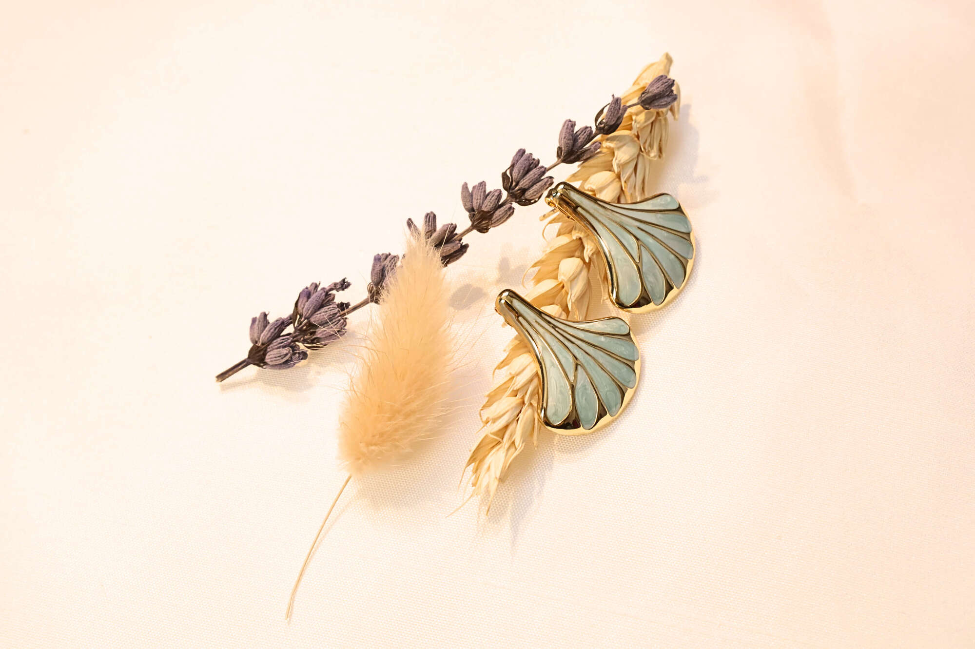 Soft turquoise seashell earrings styled with natural tones, adding a fresh and elegant touch to any look.