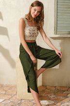 Flowy sage green capri pants with an intricately embroidered crochet top, perfect for summer outings and relaxed styling.