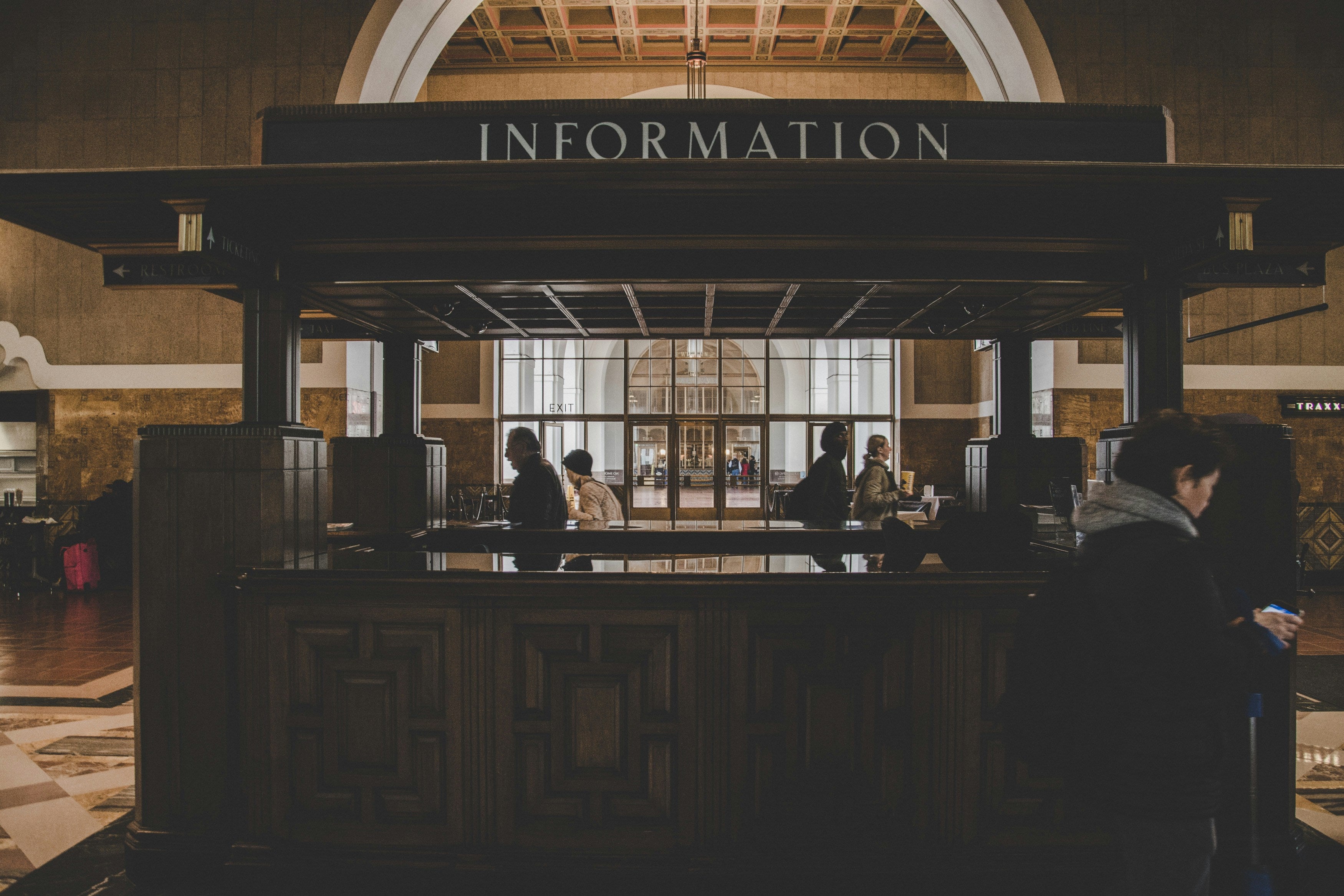 Information desk in a large building with people around