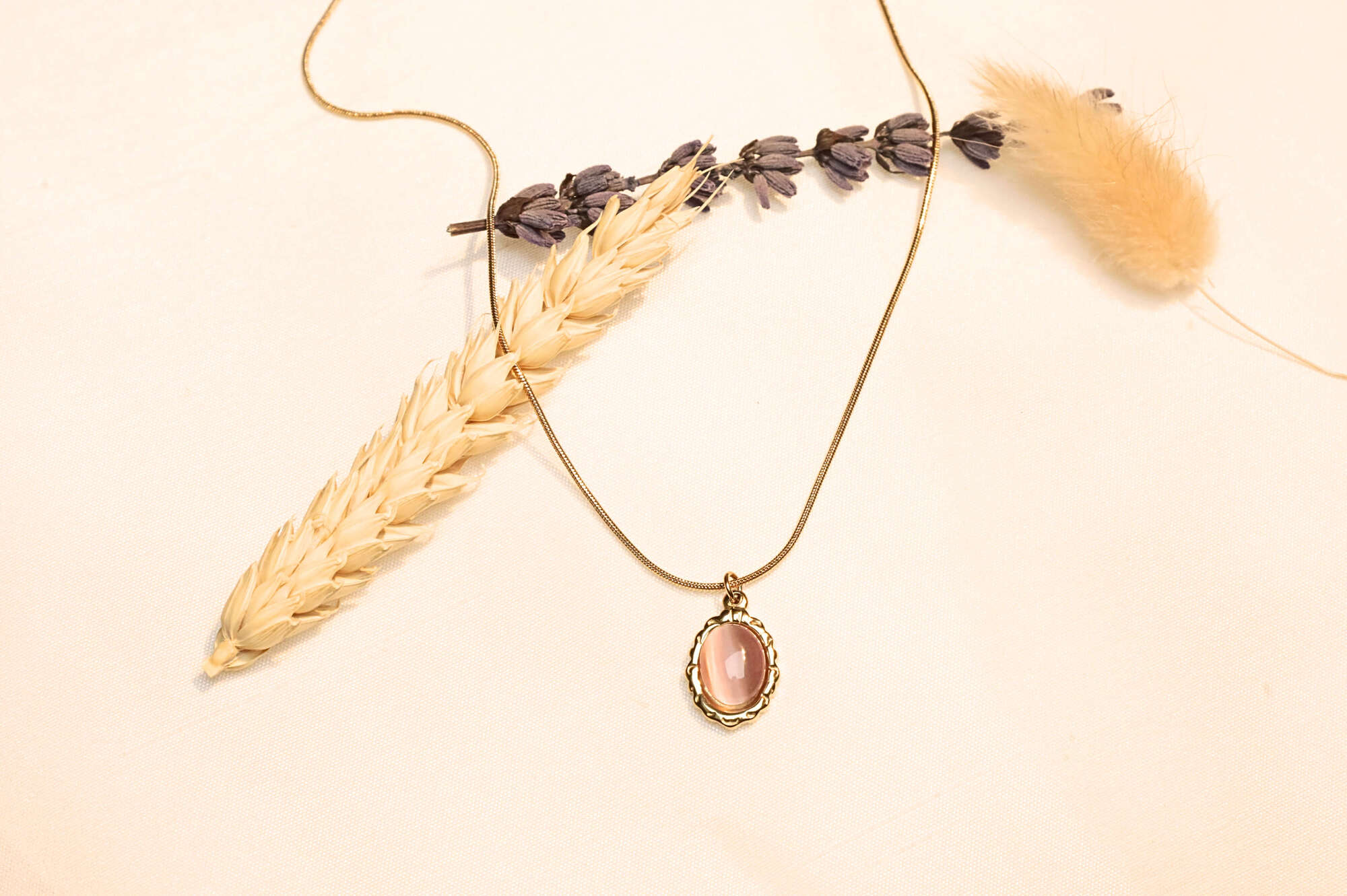 Vintage-style pink stone necklace offering timeless elegance.