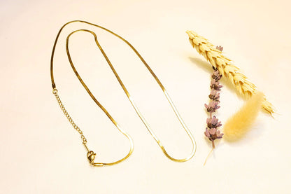 Gold-plated snake chain necklace – A fluid and elegant design that adds a modern touch.