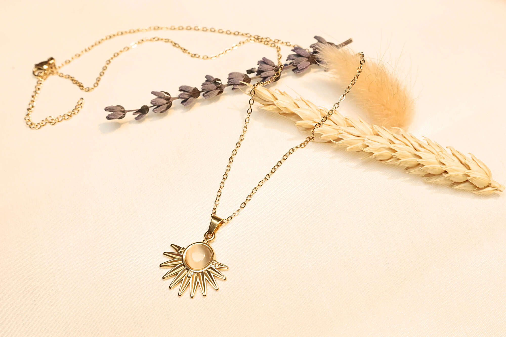 Gold-plated sun pendant necklace – A shimmering and mystical style with a pearl detail.