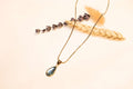 Sparkling turquoise stone and delicate chain necklace design.