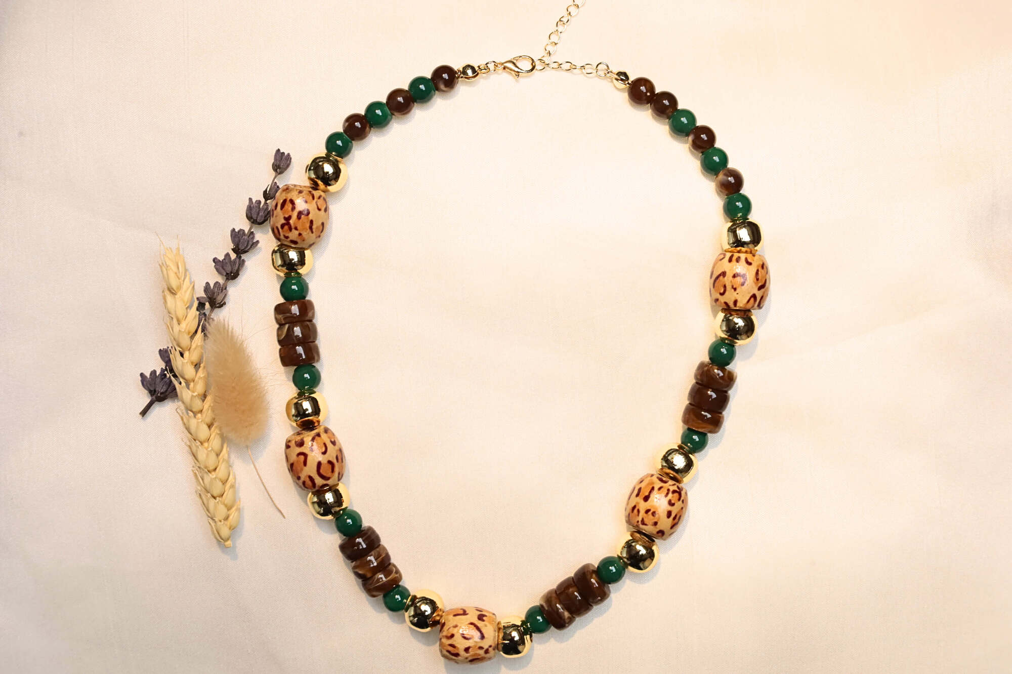 Boho-style natural wood necklace with metal bead details.