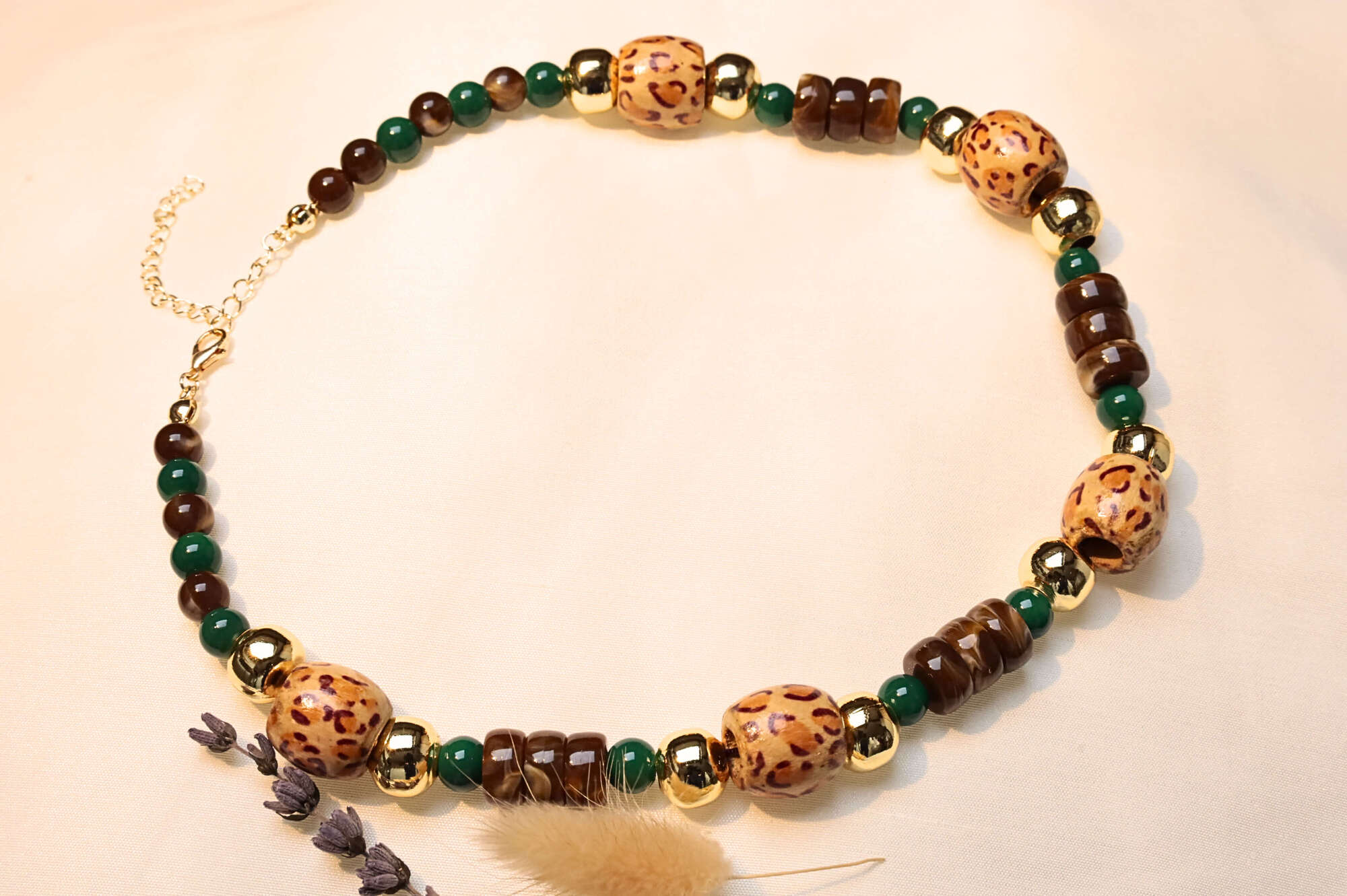 Ethnic beaded necklace with vintage charm and earthy hues.